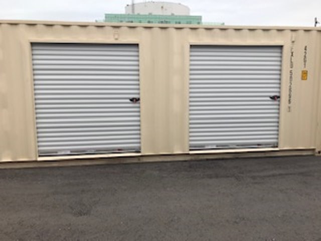 Heavy-duty weatherproof ground-level storage container units at Warden Self Storage